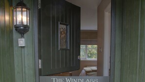 A green wooden door with a sign reading "The Windlass." - The Narrowboat At Weedon (Northampton)