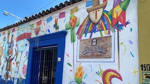A colorful mural with a heart, a sombrero, and a sign for Dona Betty Hotel.