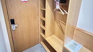 A wooden closet with a fire action sign, a do not disturb sign, and a no smoking sign. - Hill Park Hotel (Dunfermline)