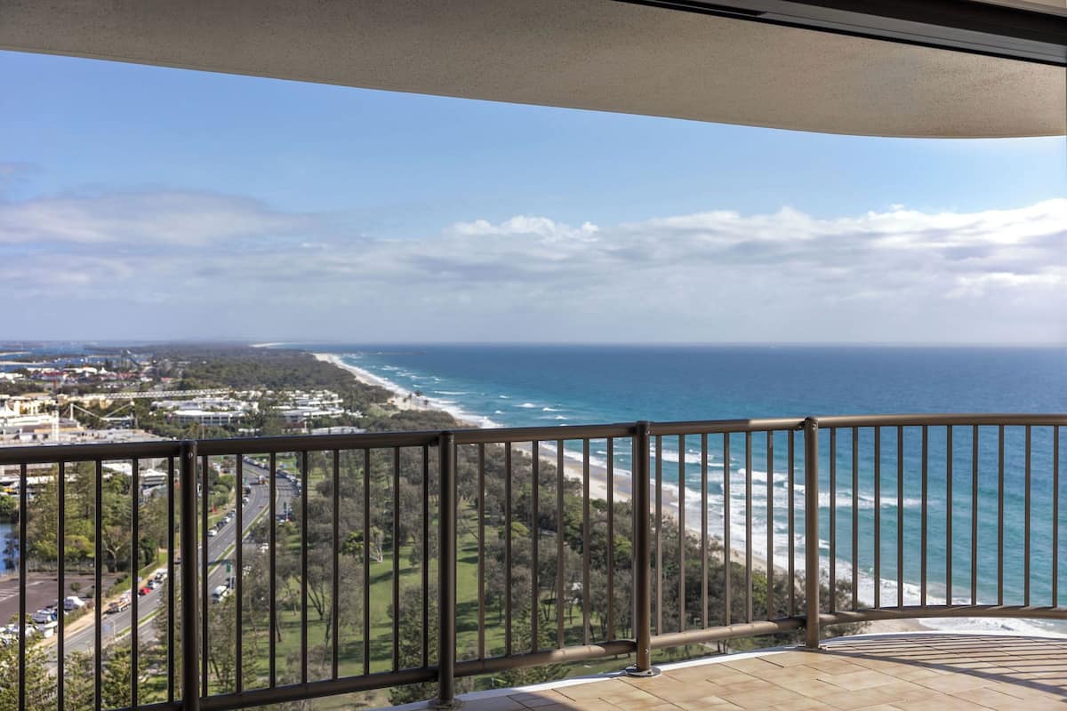 Ein Balkon mit Blick auf das Meer und eine Küstenstraße.