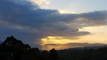 A coastal landscape with a view of the sea and distant hills.