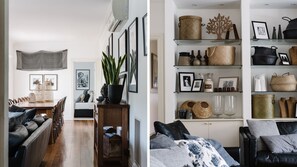 Relax in a well-organized living space with a cozy sofa, dining table, and decorative artwork.