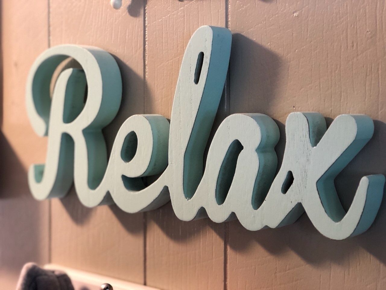 A wall with the word "Relax" in a decorative font.