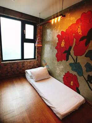 A room with a bed, a window, and a wall with a floral mural. - Hwon Guest House (Seoul)