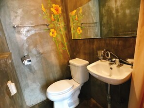 A bathroom with a white toilet, a sink, and a mirror. - Hwon Guest House (Seoul)