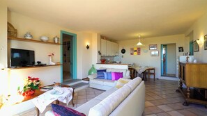 Cozy living space with a central seating area, dining table, and kitchenette.