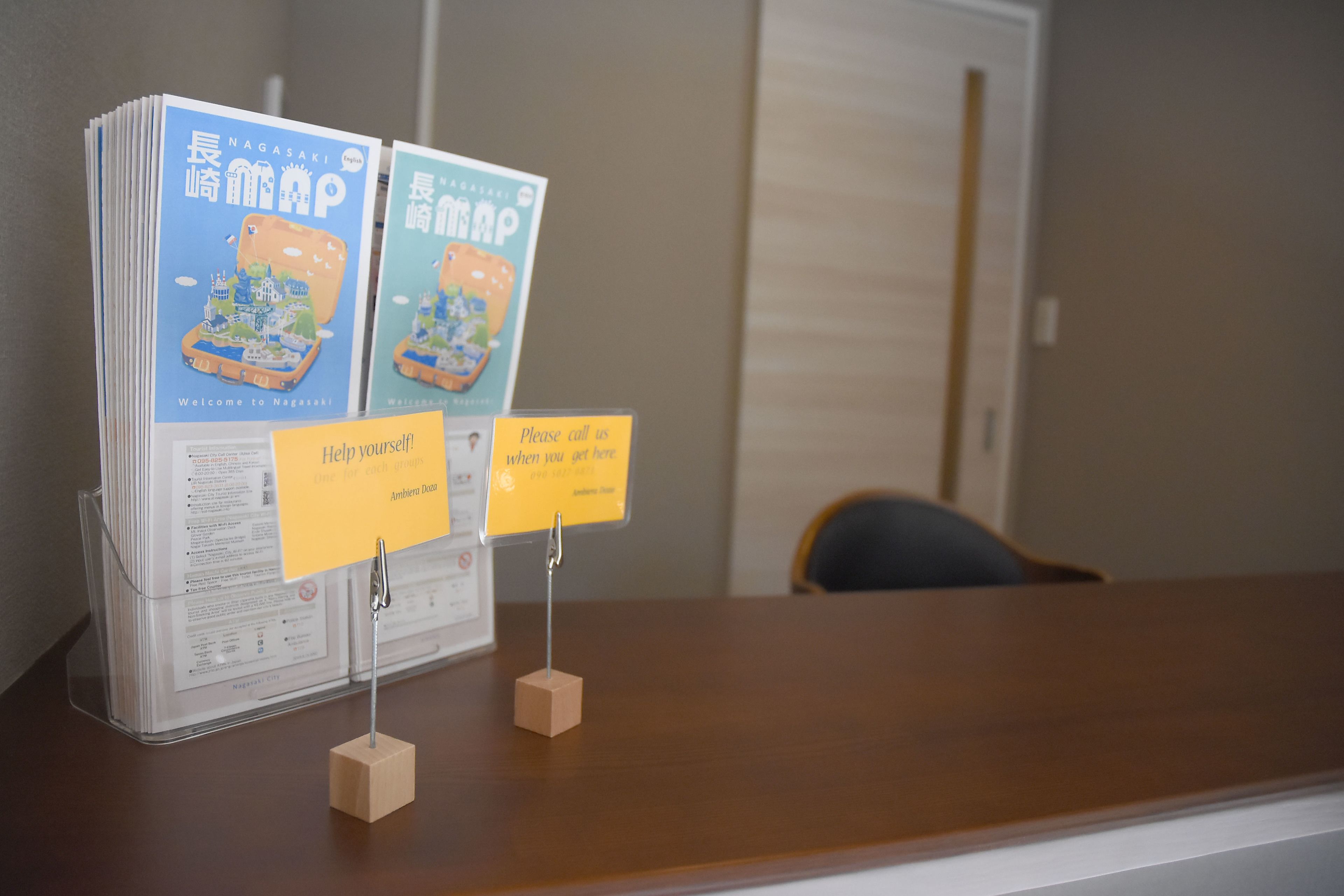 A reception desk with informational brochures and signs.