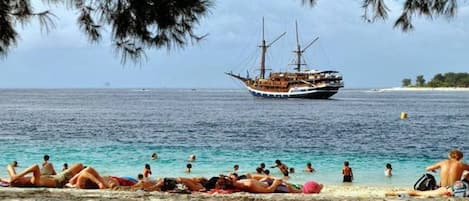 Beach nearby, white sand, rowing