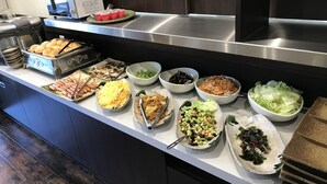 A buffet with various food items including hot dogs, eggs, noodles, and salads. - Hotel Famitic Nikko (Nikko)