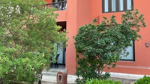 A multi-story building with balconies, a covered outdoor area, and well-maintained greenery. - South Marina Fiorita house (Hurghada)