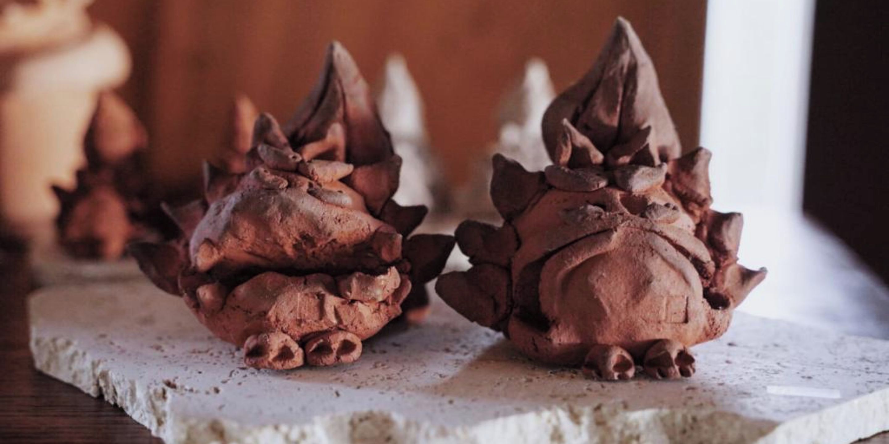 Two chocolate confections on a white surface.