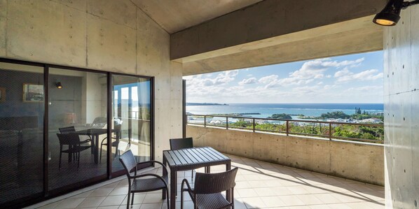 A balcony with a view of the sea and a cityscape. - Hotel Condominium Doka Doka  (Onna)