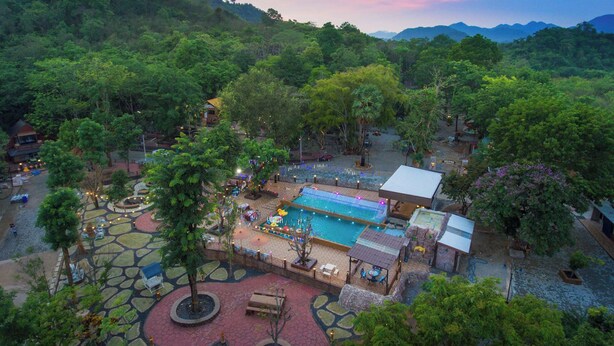 A resort with a swimming pool, outdoor seating, and lush greenery. - Bhumisiri Hill Khaoyai (Pak Chong)