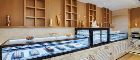 A bakery display case with various pastries and desserts.
