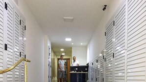 A hotel lobby with a marble staircase, lockers, and a reception desk. - Copacabana Ocean Breeze (Rio de Janeiro)