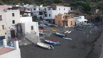 Beach nearby, black sand, beach umbrellas, beach towels