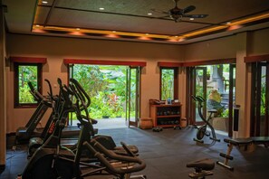A gym with treadmills, elliptical machines, and free weights.