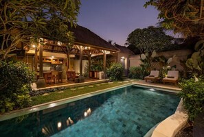 A pool with a tiled edge, a covered outdoor seating area, and lush greenery. - Ubud Nyuh Bali Resort & Spa (Ubud)