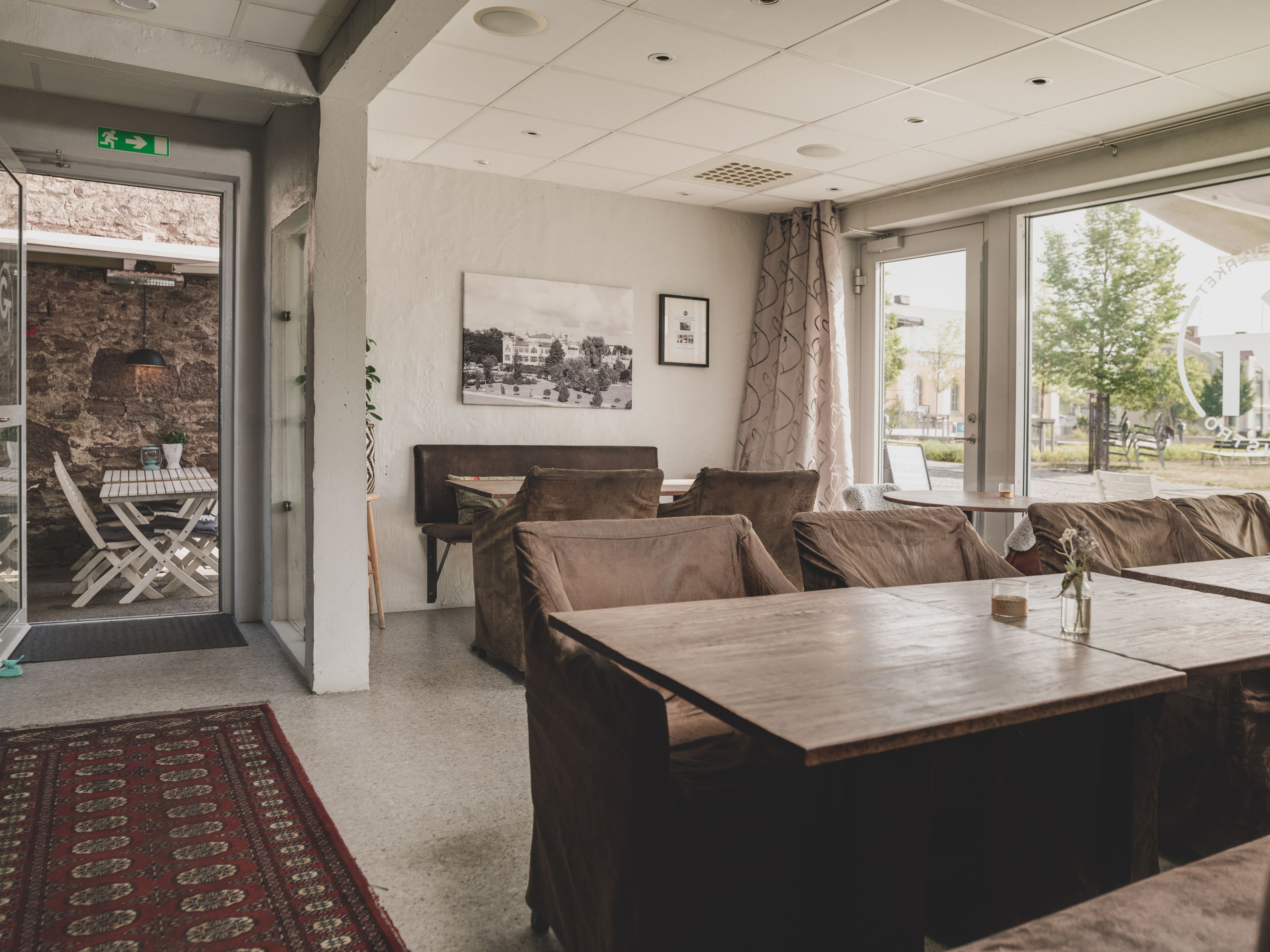 A modern interior with a seating area, a table, and a view of the outdoors.