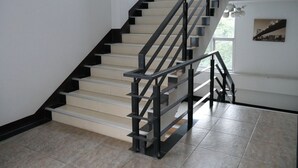 A modern staircase with black railings and beige steps, leading to an upper floor. - Sabai @ Chumphae (Chum Phae)
