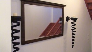 A mirror with a wooden frame mounted on a white wall. - Holiday Home Abertamy (Abertamy)