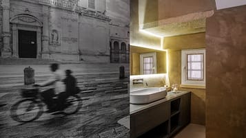 Eine historische Gebäudefassade mit aufwendigen Schnitzereien und ein modernes Badezimmer mit großem Waschbecken und Waschtisch.
