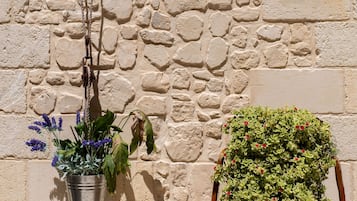 Two planters against a stone wall.
