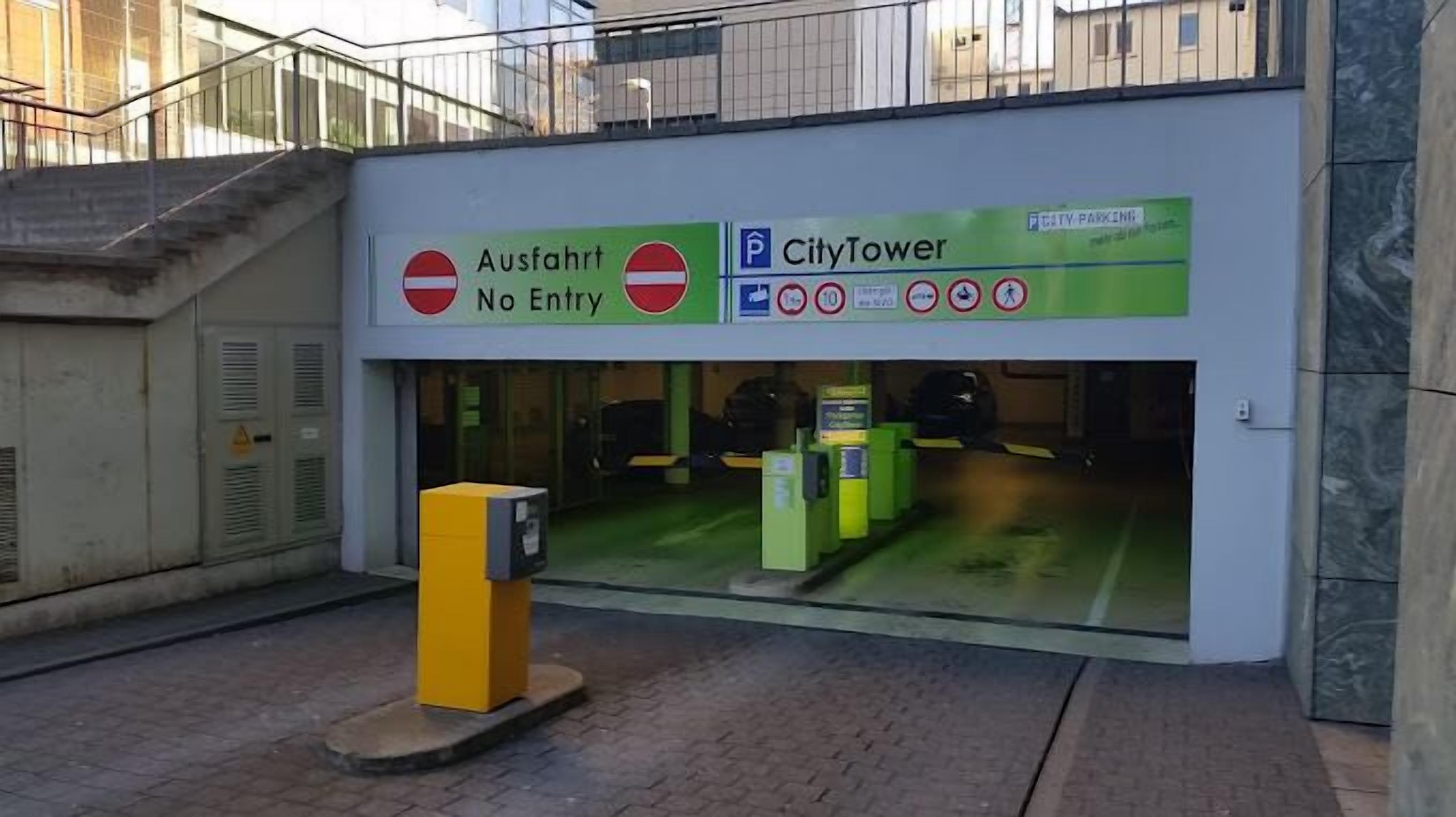 A building entrance with a 'No Entry' sign, a 'CityTower' sign, and a parking sign.