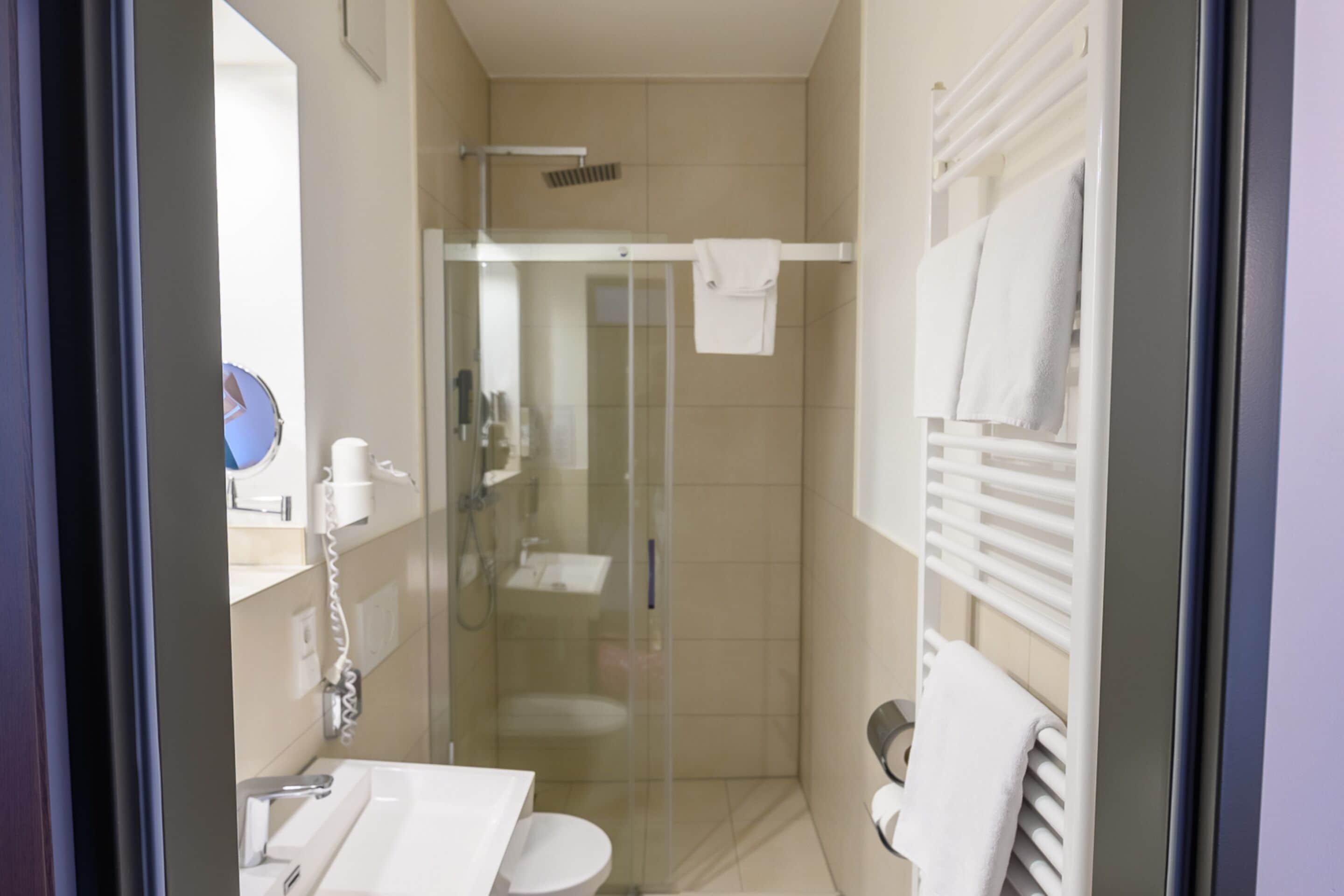 shower, hair dryer, slippers, towels