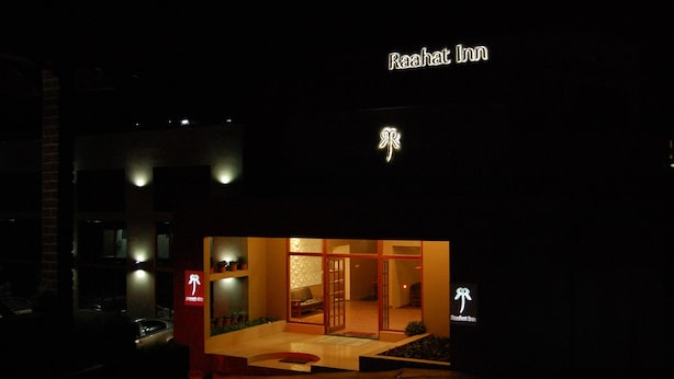 The exterior of Raahat Inn at night, featuring illuminated signage and a visible entrance. - Raahat Inn Kodaikanal (Kodaikanal)