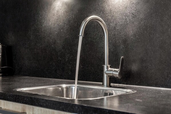A modern kitchen with a stainless steel sink and faucet. - HVZ Lotus 8p - Four Bedroom Resort, Sleeps 8 (Heinkenszand)