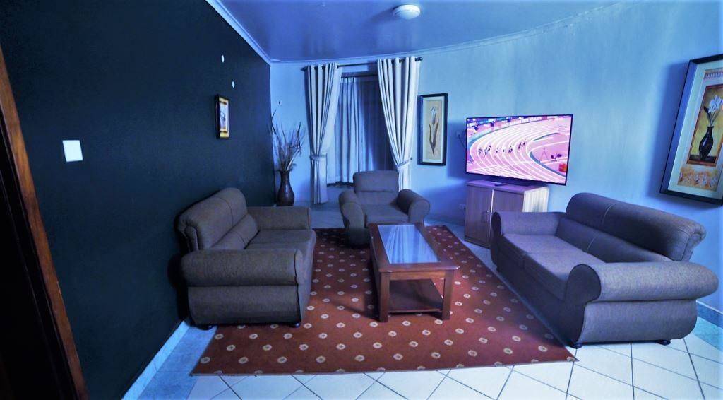 A living room with two sofas, a coffee table, and a TV on a stand.