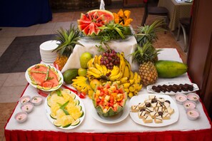 A table with various fruits, desserts, and drinks. - Silver Springs Hotel Uganda (Kampala)