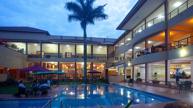 A hotel with a pool, outdoor seating, and multiple balconies. - Silver Springs Hotel Uganda (Kampala)