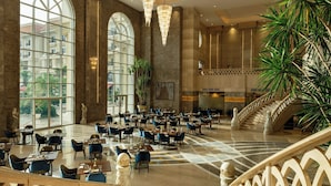 A spacious lobby with large arched windows, a grand staircase, and elegant chandeliers. - The St. Regis New Capital, Cairo (New Capital)