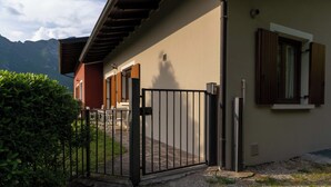 A house with a gated entrance, a wooden door, and a window with shutters. - Casa Lucia 1 - Three Bedroom Apartment, Sleeps 5 (Idro)