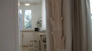 A narrow hallway leading to a room with a window, a small table, and a chair. - Apartment- Iris - One Bedroom Apartment, Sleeps 4 (Marina di Castagneto Carducci)