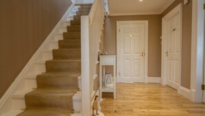A staircase with carpeted steps and white railings, leading to a door at the top. - Springfield Lodge B&B (Stirling)