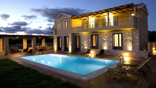 A two-story house with a swimming pool, stone exterior, and outdoor seating area. - Villas Armeno (Lefkada)