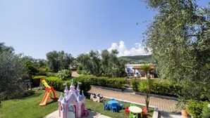 A children's play area with a castle, slide, and picnic tables. - Semi detached Villa Country (Vieste)