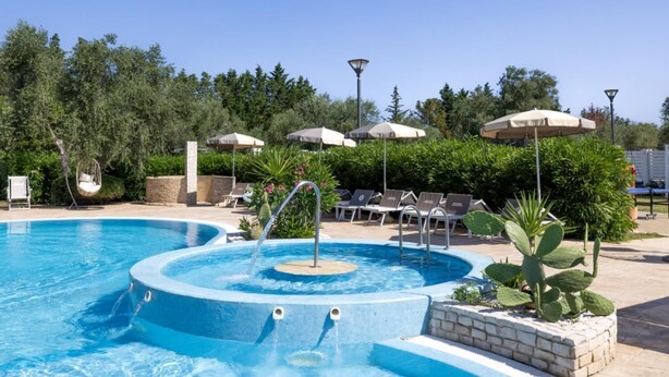 A swimming pool with a hot tub, lounge chairs, and umbrellas. - Semi detached Villa Country (Vieste)