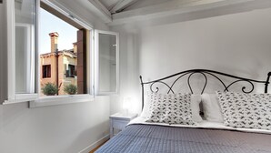 A bedroom with a bed, a window, and a nightstand. - San Marco Prestige - S Zaccaria by Wonderful Italy (Venice)