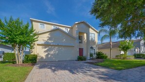 A residential house with a garage, a driveway, and a well-maintained lawn. - 616BD (Davenport)