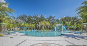 A pool area with a water slide, lounge chairs, and palm trees. - ACO PREMIUM – 8 Bd with Pool and Spa (1721) (Kissimmee)