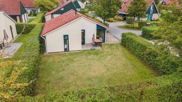 A small, single-story house with a red roof and a front porch.