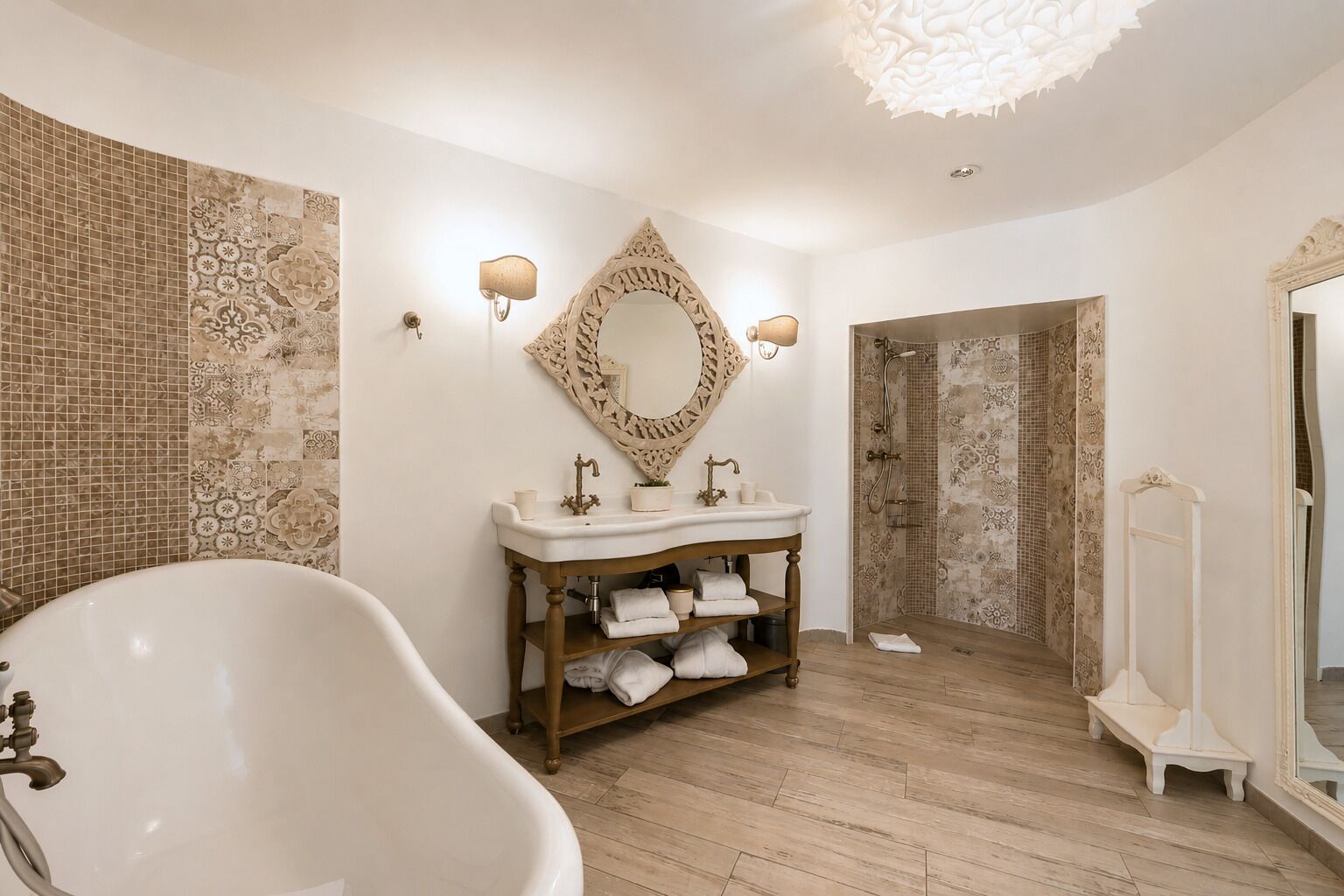A bathroom with a freestanding bathtub, a wooden vanity with a mirror, and patterned tiles on the walls.
