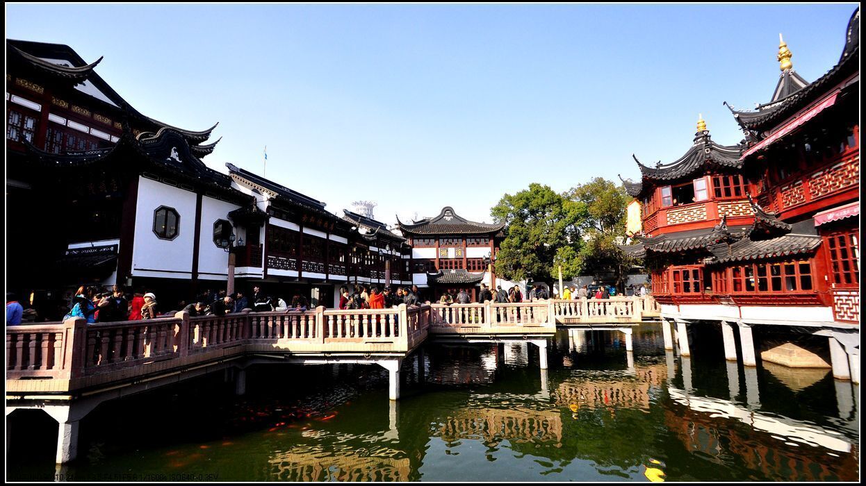 A traditional Chinese courtyard with wooden bridges and buildings.