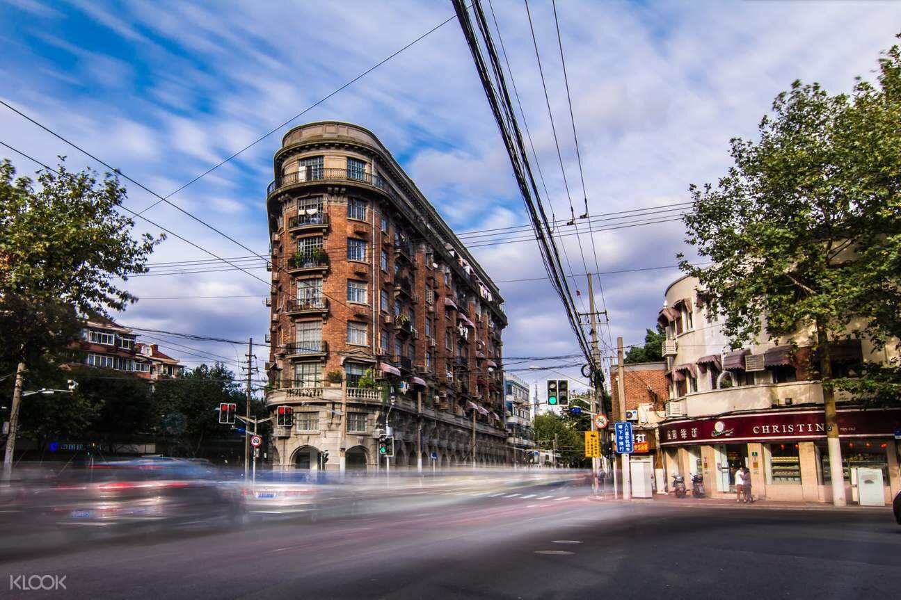 A multi-story building with a curved facade, located at a street corner.