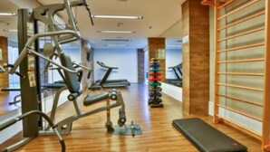 A gym with exercise equipment, treadmills, and a mirrored wall. - Maringá Airport Hotel (Maringá)