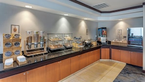 A buffet setup with various food items and a self-service station. - Fairfield Inn & Suites by Marriott Decatur at Decatur Conference Center (Decatur)